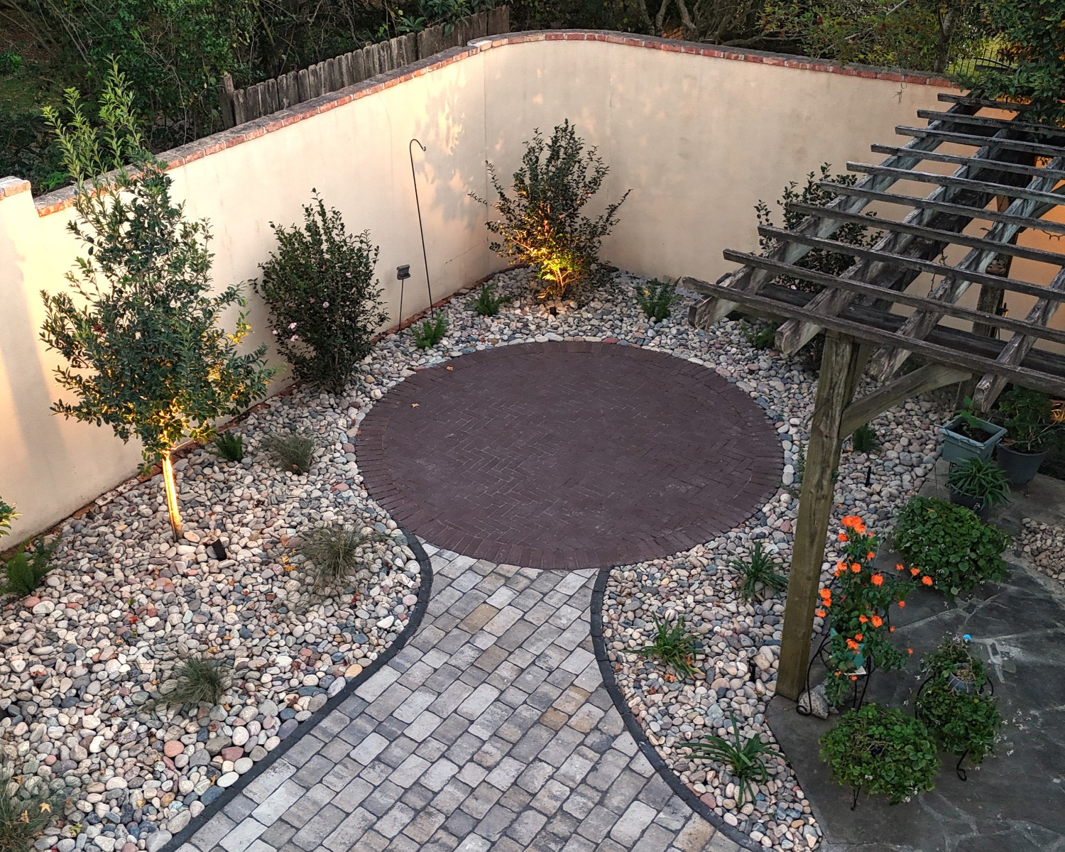 A patio with pavers and structured planting